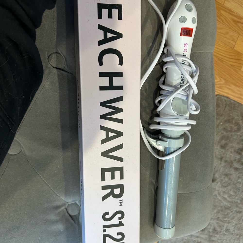 Beachwaver S1.25 Ceramic Curling Wand in Light Silver and White.